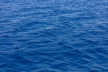 Deep blue ocean surface. Rippled sea water background texture,