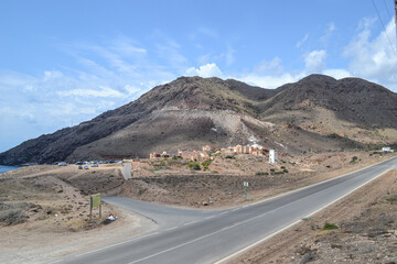 panoramic road and mountains by the sea with houses