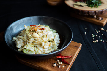 Stir-Fried Cabbage with Fish Sauce on wooden board - Asian food style