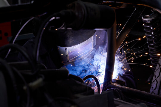 Anonymous mechanic welding parts of motorcycle