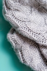 Fragment of a gray knitted plaid close-up. Vertical 