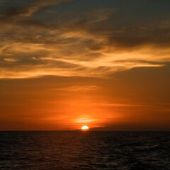 Sunset over the sea horizon.