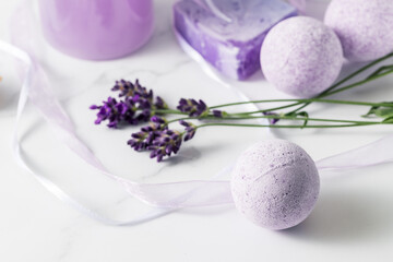 Fototapeta na wymiar Aroma bath ball bomb with lavender extract for relaxation on marble background. Home spa and wellness