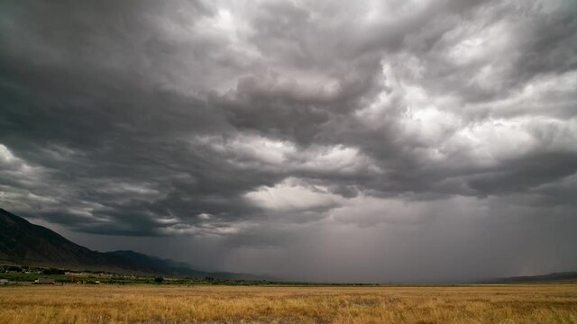 Timelapse of dramatic storm brewing over grain field with could rolling in the sky.