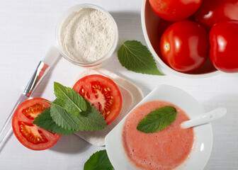 Tomatoes for skin care. Facial mask ingredients: tomatoes, white clay, mint leaves.