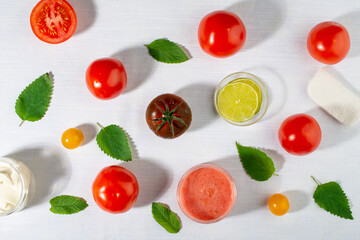 Tomatoes for skin care. Facial mask ingredients: tomatoes, lemon, mint leaves. Flat lay, top view.