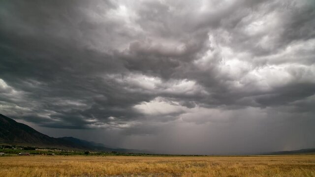 Timelapse of dramatic storm brewing over grain field with clouds rolling in the sky.