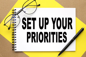 Set Up Your Priorities. text on notepad on bright stiff backing and craft background