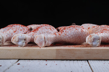 Studio lighting. wooden background in retro style. Chicken leg. Close-up.