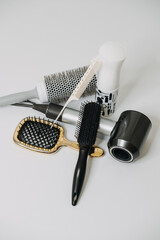 Hairdressing Tools and Equipment. Hair dryer, Paddle Brush, variety of combs, Water Bottle, Round Brush, texture iron or mini crimping iron
