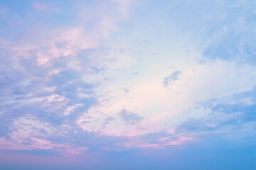 Blue clear sky with magenta gleams of the setting sun at sunset. The texture of the pink sky a...