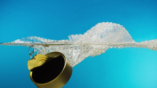 Sinking metal tin can and food wrap in the ocean, garbage in the river or lake, water pollution. Rubbish waste in the sea damage the planet, ecological and environmental problems. 