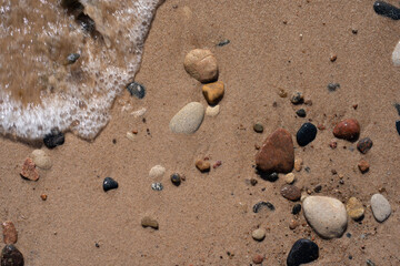 wet beach on the shores of the Baltic Sea have pebbles of different colors