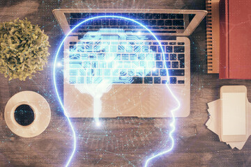 Double exposure of brain drawing hologram over topview work table background with computer. Concept of big data.