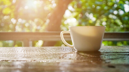Coffee mug and morning leaf bokeh