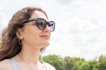 Beautiful brunette woman smiling in sunglasses with place for text. Glasses advertising,...