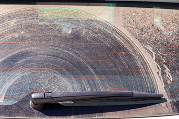 Dirt on the rear window of the car . Dirty surface background