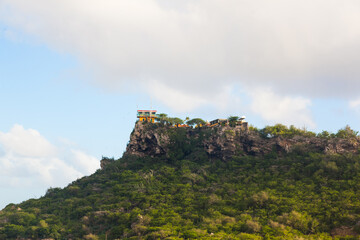 Houses on top of a mountain among dense vegetation on the island of Curacao in the Netherlands Antilles.