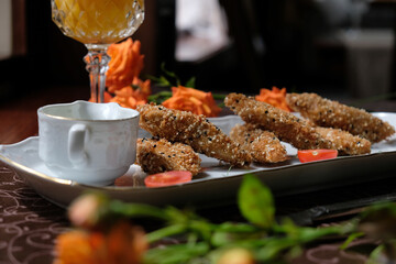 pieces of tender meat in special breading with sauce