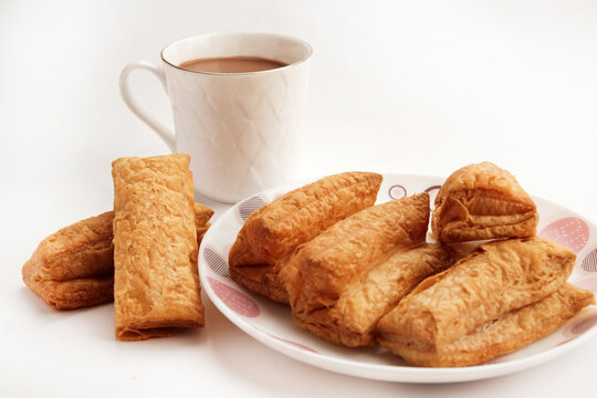 Indian khari or kharee or salty Puffy brown Snacks, served with indian hot tea, Indian Breakfast with Copy Space.