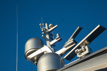 Mast of a large luxury yacht with navigation equipment, bottom view. Radars, signal lights,...