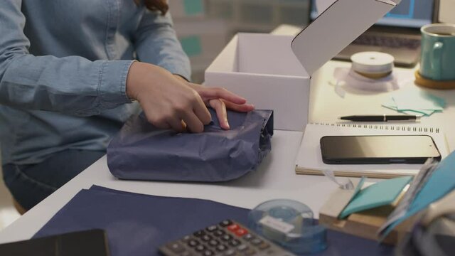 Young asia seller woman happy busy night work at home office desk in fashion studio SME online digital store social e-commerce sale page service web support. Success startup freelance job lifestyle.