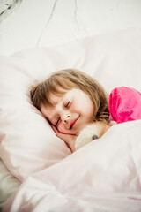 Obraz na płótnie Canvas portrait of a sleeping girl on the bed