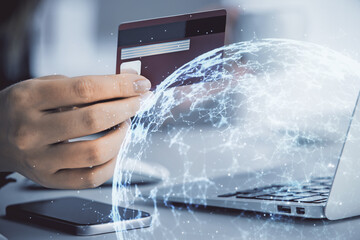 Multi exposure of woman on-line shopping holding a credit card and social network theme drawing....