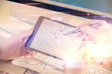 Multi exposure of man's hands holding and using a digital device and data theme drawing. Innovation...