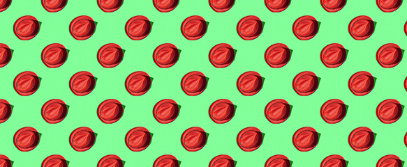 Pattern of straw hats on green pastel background