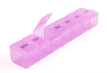 Pink plastic organizer, for pills isolated on white background. Close up on compartments pill case...