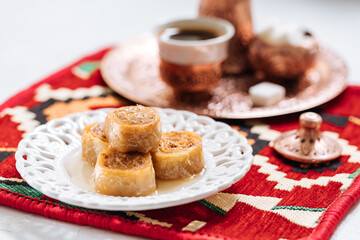 Bosnian and Turkish dessert called Ruzica served in a traditional way with coffee