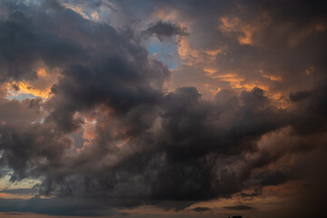 Fototapeta premium a dark thundercloud on the background of sunset