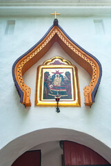 The city of Pechora. Russia. The Holy Dormition Pskov-Pechersk Monastery. The icon of the Assumption of the Most Holy Theotokos on the Petrovsky gate Tower 