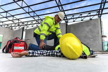 Accident at work of construction worker at site. Builder accident falls scaffolding on floor, First aid team rushed in to take care prepare helps employee accident. Safety in work concept.