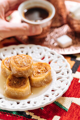 Bosnian and Turkish dessert called Ruzica served in a traditional way with coffee