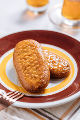 Bosnian and Turkish dessert called Hurmasica served on a grey background with cup of coffee