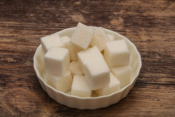 Refined white sugar cubs in the bowl