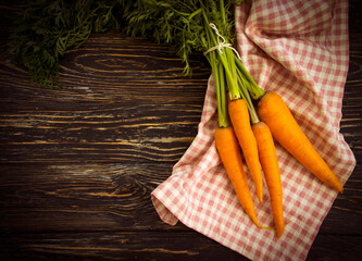 fresh carrots on wooden background