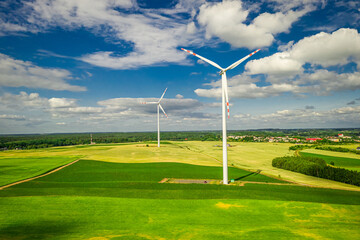 Wind turbines on green field. Agriculture and alternative energy, Poland.