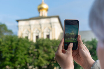 Adult tourist taking photo – Sergiev Posad, Russia. Greatest Russian monastery of Golden Ring. Summertime wanderlust concept scene.