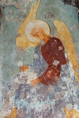 Fragmented ancient wall fresco with weathered textures and faded natural colors
