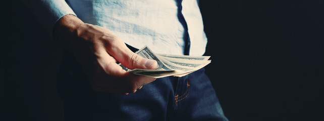 man counts money calculating finance