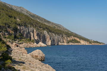 Beautiful view of the rocky shores flowing straight into the Adriatic Sea around the island of Hvar - obrazy, fototapety, plakaty