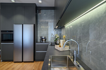 Modern large luxury dark gray kitchen closeup