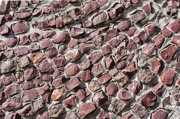 An Old Artistic Grunge Texture. Background of Wall of granite multicolored stones and concrete