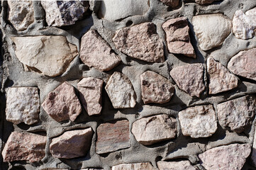 An Old Artistic Grunge Texture. Background of Wall of granite multicolored stones and concrete