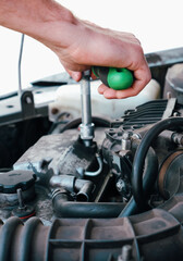 Fototapeta premium Car repair. Auto mechanic working on car engine in mechanics garage. Repair service. close-up shot