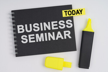 On a white background lies a marker and a notebook with a TODAY sticker and the inscription - BUSINESS SEMINAR