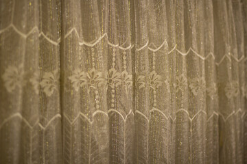 The curtains are in the room. Decoration of the window with a cloth.